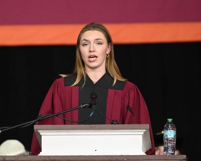 A woman speaks from a podium.